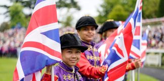 70 Local schoolchildren dressed in the Queen's silks
