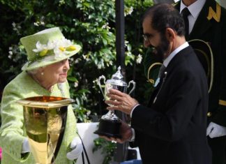 Queen Elizabeth II presents Sheikh Mohammed bin Rashid, Vice President and Ruler of Dubai, with the Diamond Jubilee trophy.
